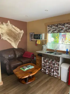 a living room with a couch and a table at 1868 Noble Cottage in Clearwater