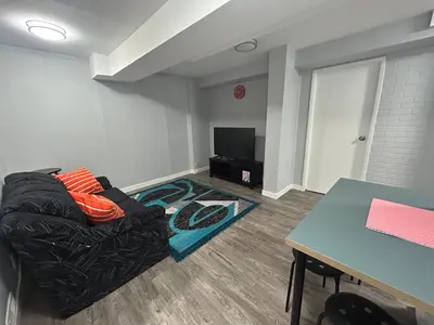 a living room with a couch and a table at Cute Highlandpark (Lower A Unit) in Calgary