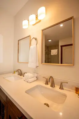 a bathroom with a sink and a mirror at River Safari Lodge in Blue River