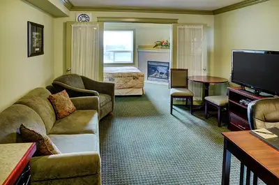 a living room with a couch and a television at Nova Inn Edson in Edson