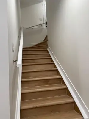a hallway with a staircase in a building at Modern 2Bedroom suite in SW Edmonton close to Edmonton International Airport in Edmonton