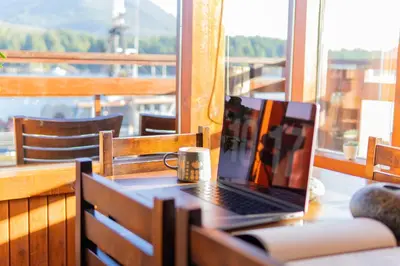 a laptop computer sitting on a table on a balcony at Waterfront Condo in Ucluelet in Ucluelet