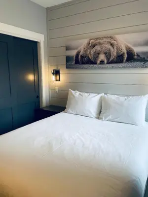 a bedroom with a bed with a picture of a bear at Family friendly 2BR/2BA condo - Views & Location!! in Canmore
