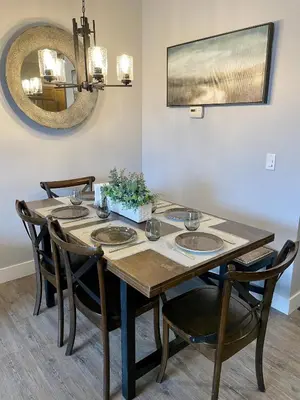 a dining room table with four chairs and a mirror at Family friendly 2BR/2BA condo - Views & Location!! in Canmore