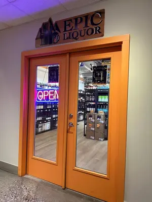 an orange door to a store with a sign above it at Solara Escape - 2BR Retreat with Pool - Hot Tub - Gym - Spa in Canmore