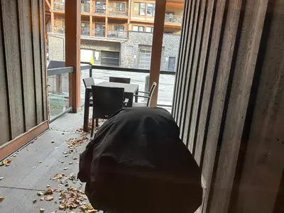 a room with a table and chairs and a window at Solara Escape - 2BR Retreat with Pool - Hot Tub - Gym - Spa in Canmore