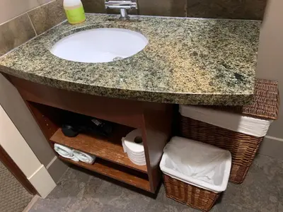 a bathroom with a sink and a counter at Solara Escape - 2BR Retreat with Pool - Hot Tub - Gym - Spa in Canmore