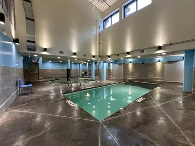 a pool in the middle of a room at Solara Escape - 2BR Retreat with Pool - Hot Tub - Gym - Spa in Canmore