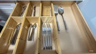 a wooden drawer with silver utensils in it at Solara Studio with Pool/Hot tub/Parking/Gym in Canmore