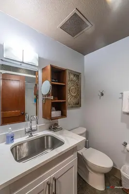 a bathroom with a sink and a toilet at Solara Studio with Pool/Hot tub/Parking/Gym in Canmore