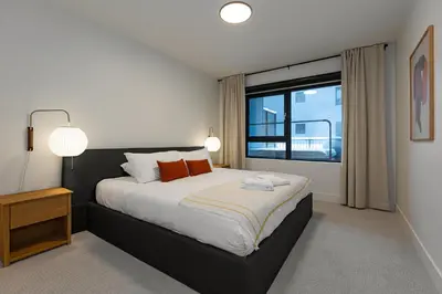 a bedroom with a large bed and a window at Tally Ho by Revelstoke Vacations in Revelstoke