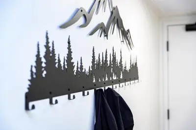 a black and white forest wall art on a wall at Separate Reality Retreat by Revelstoke Vacations in Revelstoke
