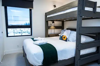 a bedroom with a bunk bed next to a window at Separate Reality Retreat by Revelstoke Vacations in Revelstoke