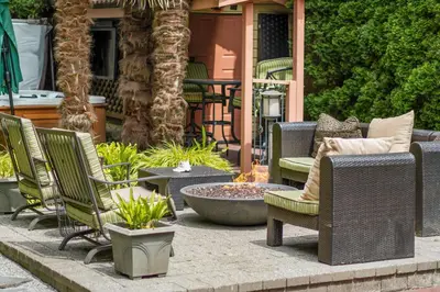a patio with wicker chairs and a fire pit at Luxury Retreat in Vancouver in Vancouver