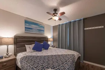 a bedroom with a bed and a ceiling fan at B211 MTN View ground floor town house- 2BD, Sleeps 8, hot tub, free parking, close to Banff in Canmore