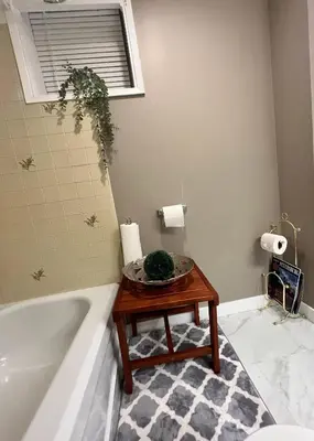 a bathroom with a table next to a bath tub at West Edmonton Perle Palace in Edmonton