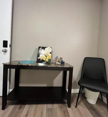 a desk with a laptop on it with a chair at West Edmonton Perle Palace in Edmonton