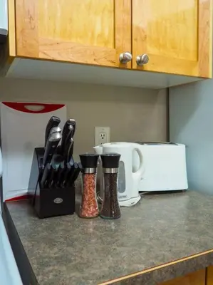a kitchen counter with some utensils and rubber boots at Cozy apartment in the heart of Panorama in Panorama