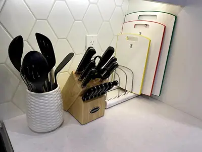 a knife block with a bunch of knives on a counter at Luxury unit in the heart of Canmore in Canmore