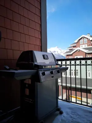 a grill sitting on a table next to a balcony at Sweet Condo Canmore GR\uff1a\uff09 in Canmore