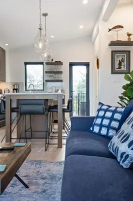 a living room with a couch and a table at Ocean View Townhouse #26 at THE BEACH HOUSE in Campbell River