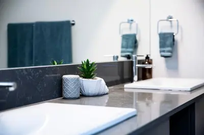 a bathroom counter with a sink and a mirror at Revelstoke Marvel - Two Bedroom with Hot Tub in Revelstoke