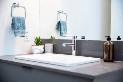 a bathroom counter with a sink and a mirror at Revelstoke Marvel - Two Bedroom with Hot Tub in Revelstoke