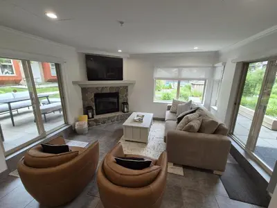 a living room with two couches and a fireplace at Cascade by Elevate Vacations in Whistler