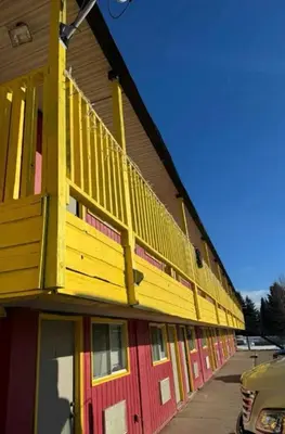 a yellow and red building with a balcony on it at The 22 Hotel in Cremona