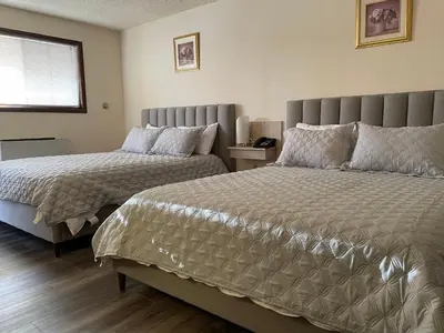 a bedroom with two beds and a window at The 22 Hotel in Cremona