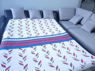 a bed and a couch in a room at Cozy 2-Bedroom Basement Suite Retreat Calgary in Calgary