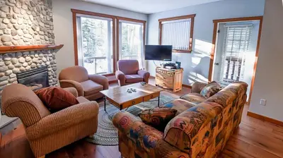 a living room with a couch and a fireplace at Polar Peak Chalet by Fernie Lodging Company in Fernie