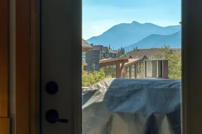 a view from a door with a view of a mountain at Mountain Escape sleeps 10 Guests in this 3BD 2BT Top Floor Condo with Mountain View in Canmore