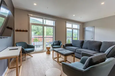 a living room with a couch and chairs at Basecamp Suites Revelstoke in Revelstoke