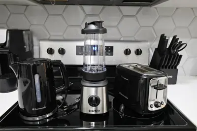 a blender sitting on top of a kitchen counter at Queen Suite 20 Min from YEG Airport with Disney in Edmonton