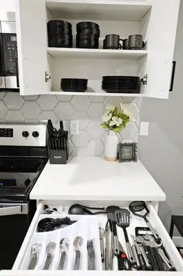 a kitchen with a white counter top with utensils at Queen Suite 20 Min from YEG Airport with Disney in Edmonton