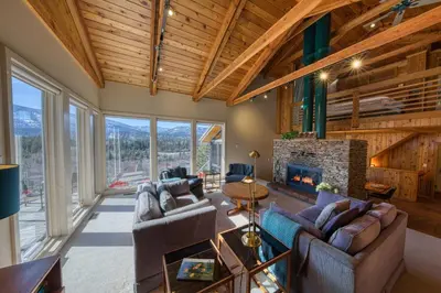 a living room with couches and a fireplace at CLIFF CABIN Family Friendly|Hot Tub|Spectacular Views in Fairmont Hot Springs