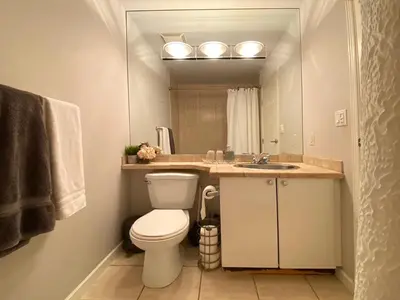a bathroom with a toilet and a sink at Richard Comfort Living in Vancouver