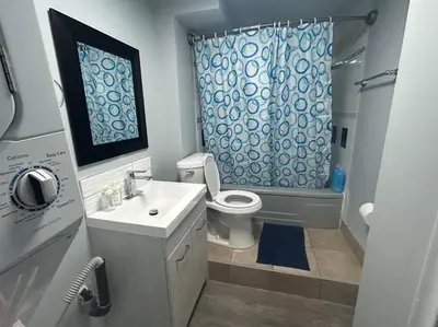 a bathroom with a sink and a toilet and a shower at Cute Highlandpark (Lower B Unit) in Calgary