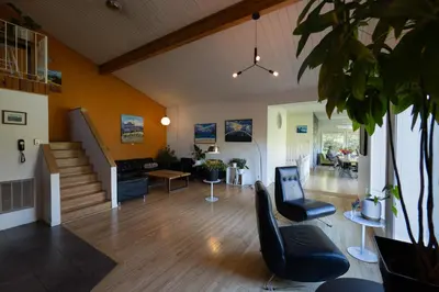 a living room with a staircase and a couch at Boreale Ranch in Carcross