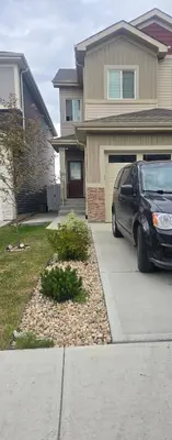a car parked in front of a house at Cozy Basement Suite - private entrance - Free Netflix in Edmonton
