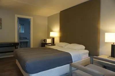 a hotel room with a large bed and a desk at The Mighty Fraser Motel in Boston Bar