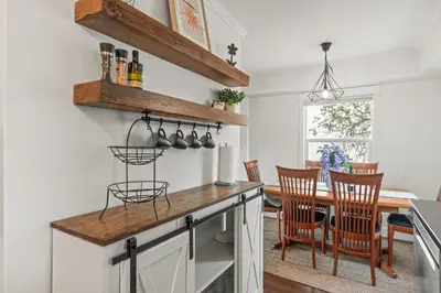 a kitchen and dining room with a table and chairs at Stunning Heritage Home, Sleep 8, Hot Tub, Private Yard, Firepit in Vernon