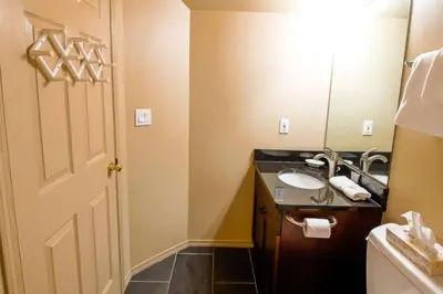 a bathroom with a sink and a mirror at Thunder Ridge Chalet by Fernie Lodging Company in Fernie