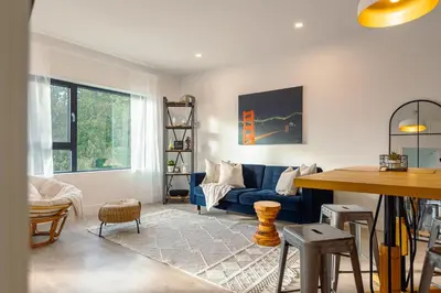 a living room with a blue couch and a table at Revelstoke Alpine Retreat - RARE One-Bedroom Condo in Revelstoke