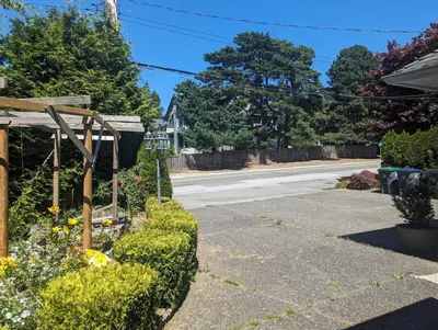 an empty street with a house and a road at Ocean Park Loft in Surrey