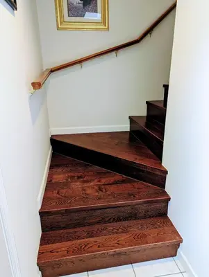 a stairway with wood floors and a picture on the wall at Ocean Park Loft in Surrey