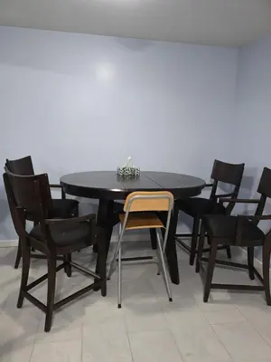 a black dining room table with black chairs at Private basement suite in Langley