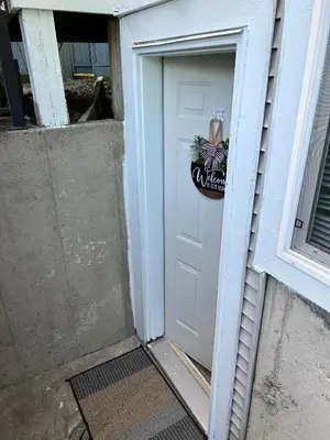 a white door with a sign on it at Private basement suite in Langley