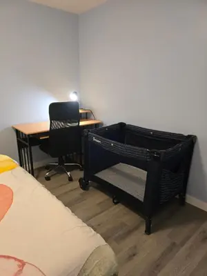 a bedroom with a desk and a chair and a bed at Private basement suite in Langley